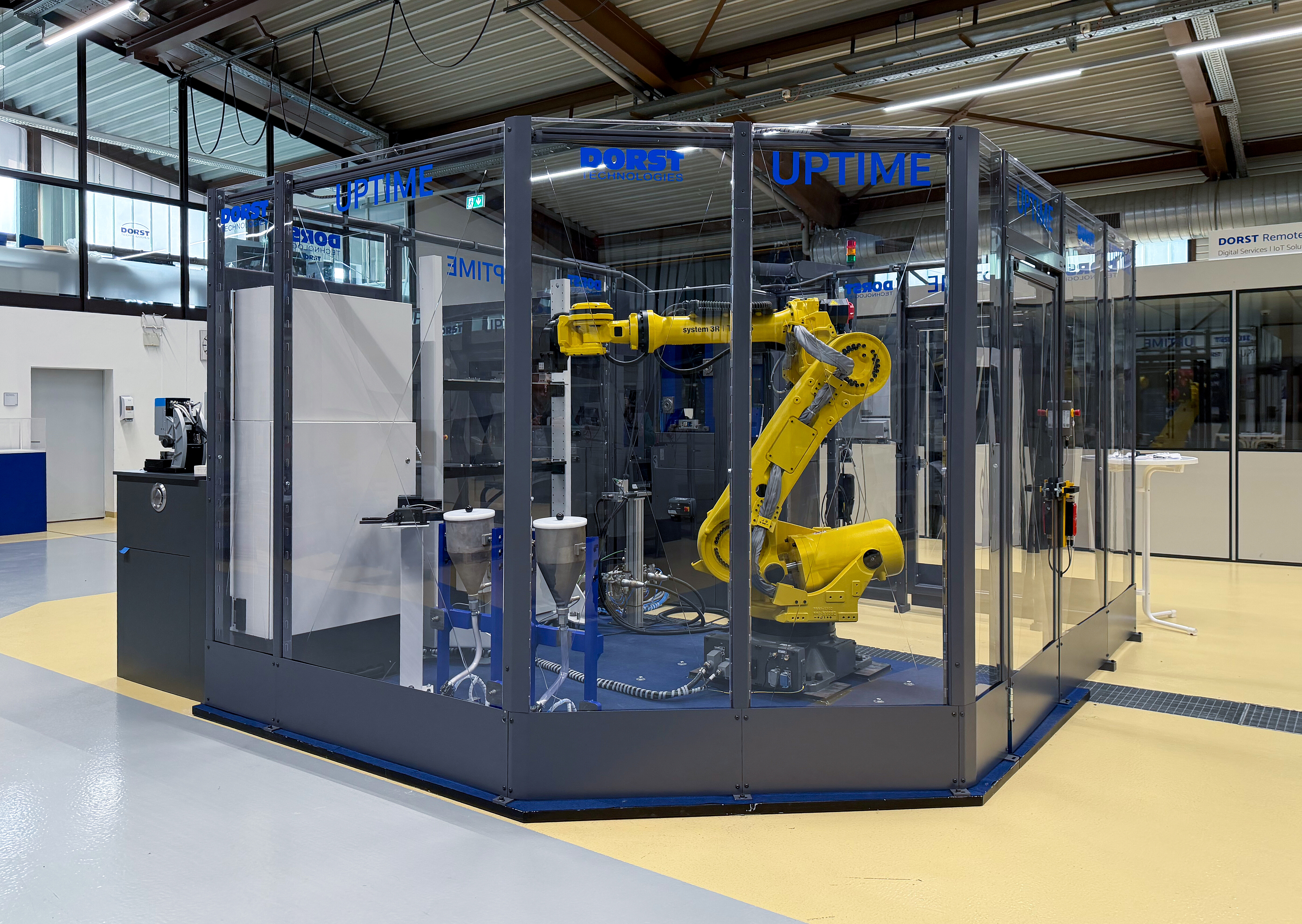 Rear view of the UPTIME automated production cell, showing the robot, press and enclosed handling area